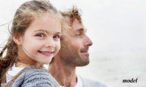 Close Up of Smiling Little Girl with Dad at Beach